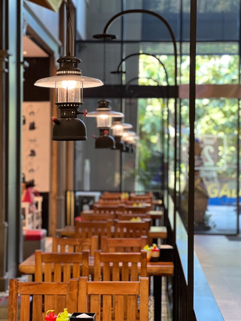 A restaurant with wooden tables and wooden chairs